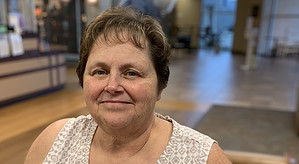 Happy woman at Guttenberg Hospital, smiling after treatment.