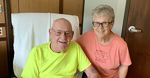 Elderly man and woman smiling in hospital room at Guttenberg Hospital.