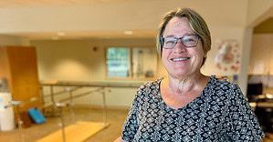 Senior woman smiling at Guttenberg Hospital healthcare facility.